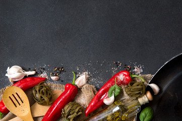 Vegetables,  fresh herbs, hot spices and household goods stacked on a stone countertop. Photo includes a copyspace