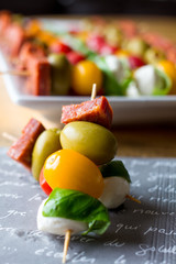 antipasto skewers on a white plate 