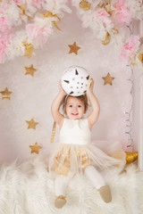 Cute smiling girl with a big Christmas ball