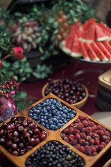tasty berries on the wedding buffet table decorated with flowers