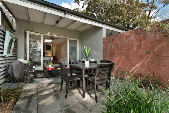 back yard with outdoor seating and barbecue with family
