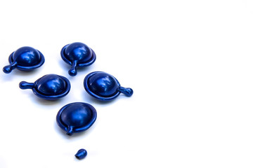 Hair vitamin serum capsule blue color on white background.