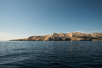 Fototapeta na wymiar Blue water and empty island. Landscape.