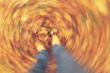 Fototapeta na wymiar Motion Blur Walking in Autumn Fall Leaves