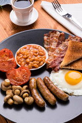 rustic full english breakfast on black plate