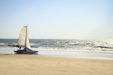 catamaran yacht standing on a deserted beach
