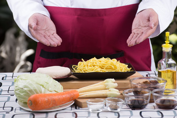 Chef present ingredient of stir fry vegetarian Noodle