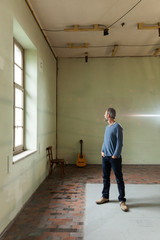 Portrait of man with guitar, the industrial location