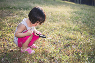Asian Chinese Little Girl Exploring With Magnifying Glass