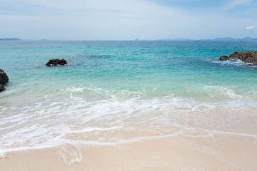Sea waves and beautiful beach and white sand, with blue water