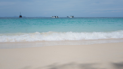Fototapeta premium Sea waves and beautiful beach and white sand, with blue water