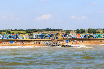 Fototapeta na wymiar Row of beach huts on Southwold Beach in UK
