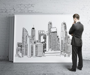 Man looking at city sketch