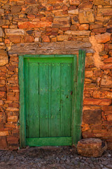 Fototapeta na wymiar Antique wooden door in a stone house