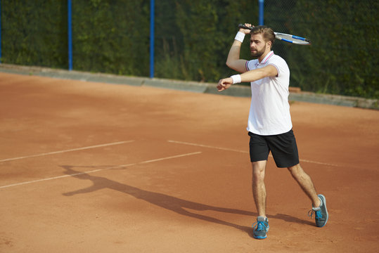 Tennis player with racket on the court