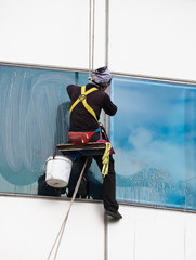 workers cleaning windows on high rise building
