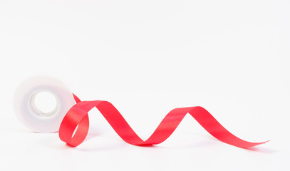 Red ribbon and roll on white background