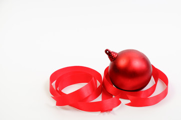 Red Christmas ball and ribbon on white background