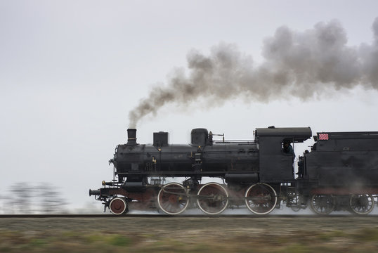 Old steam locomotive running on rails