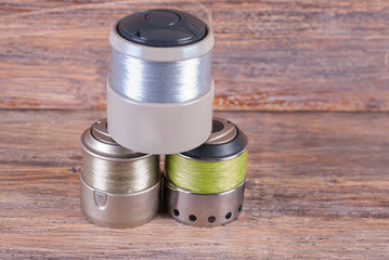 Spool spool wound with a fishing line. Wooden background