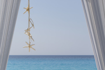 Beautiful beach and sea view with sea stars decoration © Ivan Stanic