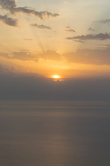 Orange sunset over the cloudy sky over calm sea 1