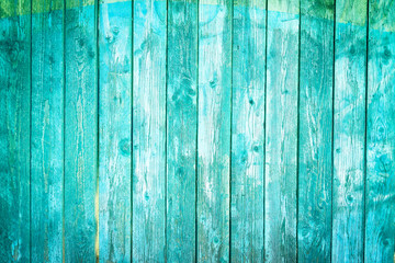 Fototapeta na wymiar Old blue wood planks background with peeling paint 