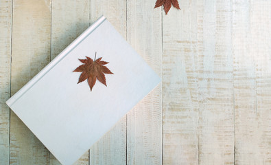 Maple leaf on the white book