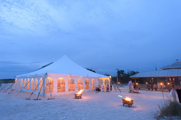 wedding reception tent on beach evening shot © Karl