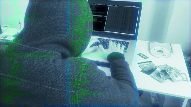 Source Code Hooded Hacker Working On A Computer. A hacker is a highly skilled computer expert. Someone who seeks and exploits weaknesses in a computer system or computer network