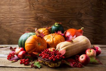 Abundant harvest concept with pumpkins, apples, berries and fall