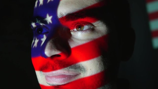 American USA flag projection over the face of a man.