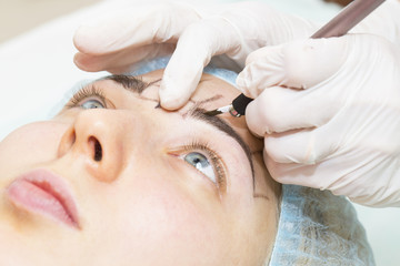 Obraz na płótnie Canvas Mikrobleyding eyebrows workflow in a beauty salon