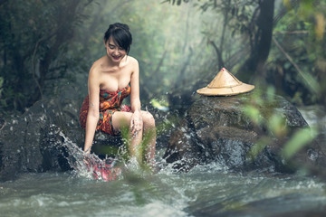 Asian sexy woman bathing in creek, Thailand