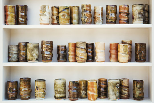 Ceramic jars arranged in rows on shelves