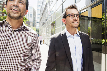 Two men walking down a city street.