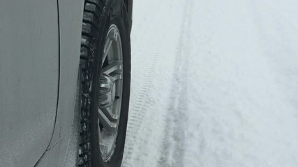 Wheels of a car traveling on winter roads.