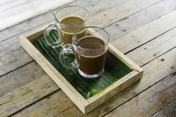 Old traditional Thai style coffee and hot chocolate or cocoa on the wooden table, selective focus