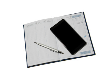 Smartphone and pen lying on the diary