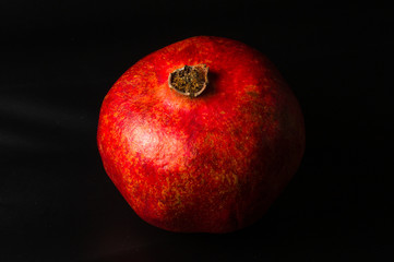 Pomegranate on black background