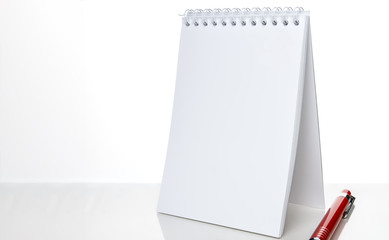 blank notebook and pen on the table