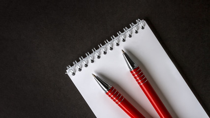 blank notebook and pen on the table