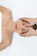 Young Woman Getting Facial Massage in Spa Center