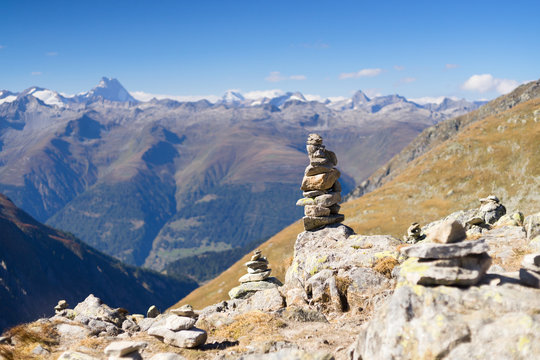 Stone cairn at the Nuffenen Pass in Swiss Alps. Selective focus.