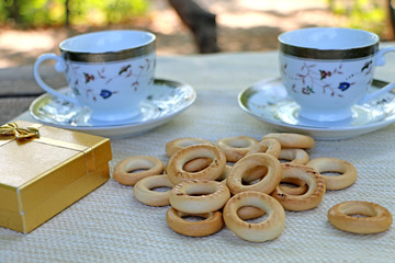 in nature, on the table bagels and cups, gift