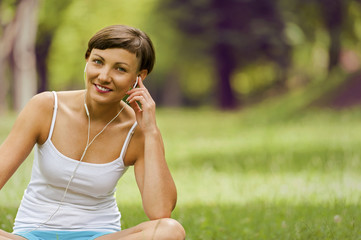 Relaxed woman listening music smiling.