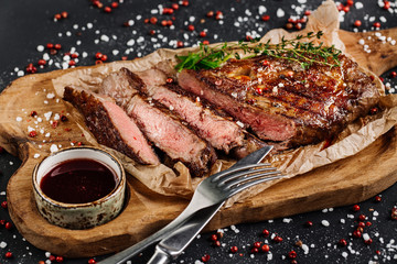 Beef rump steak from marble beef medium rare with sauce on wood