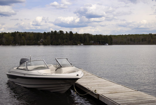 Motor Boar Tided to wood Dock on a Lake