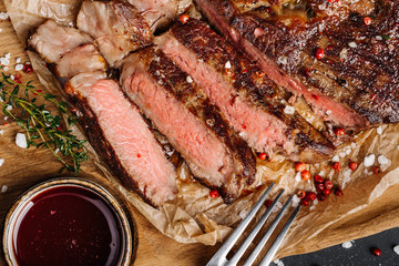 Beef rump steak from marble beef medium rare with sauce on wood