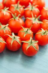 Small cherry tomatoes on a blue wooden
